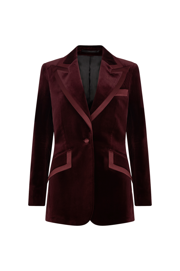 A single breasted, slim line tailored tux jacket cut from plush red velvet with a silk satin peak lapel, featured with angled side pockets and a covered button at the front.